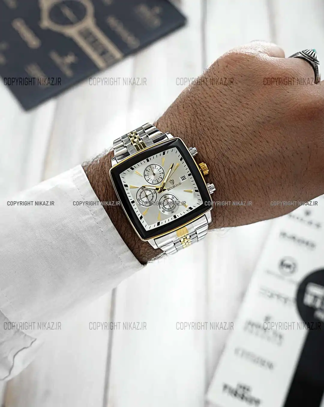 ساعت مچی مردانه بین باند BINBOND مدل صفحه مربعی کد 1613 بند نقره ای طلایی و صفحه مربعی سفید و جنس استیل رنگ ثابت و سه موتور فعال کرنوگراف و اورجینال